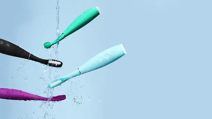 Issa 4 collection silicone sonic electric toothbrushes mid air on a light blue background